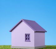A lilac house against a blue sky