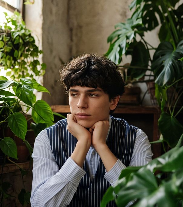 A thoughtful young man among plants
